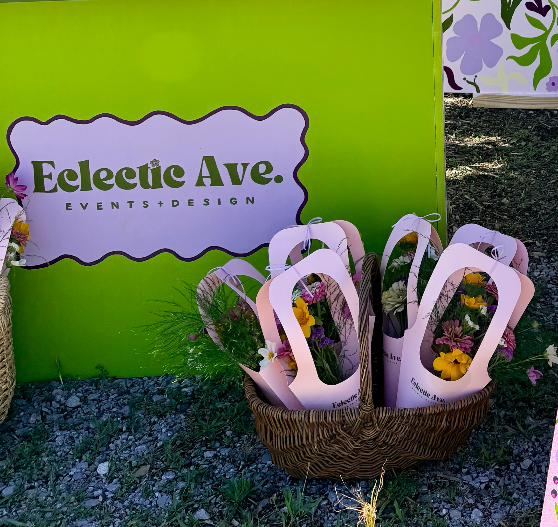 Basket of wrapped wildflower bouquets in front of the Eclectic Ave. backdrop