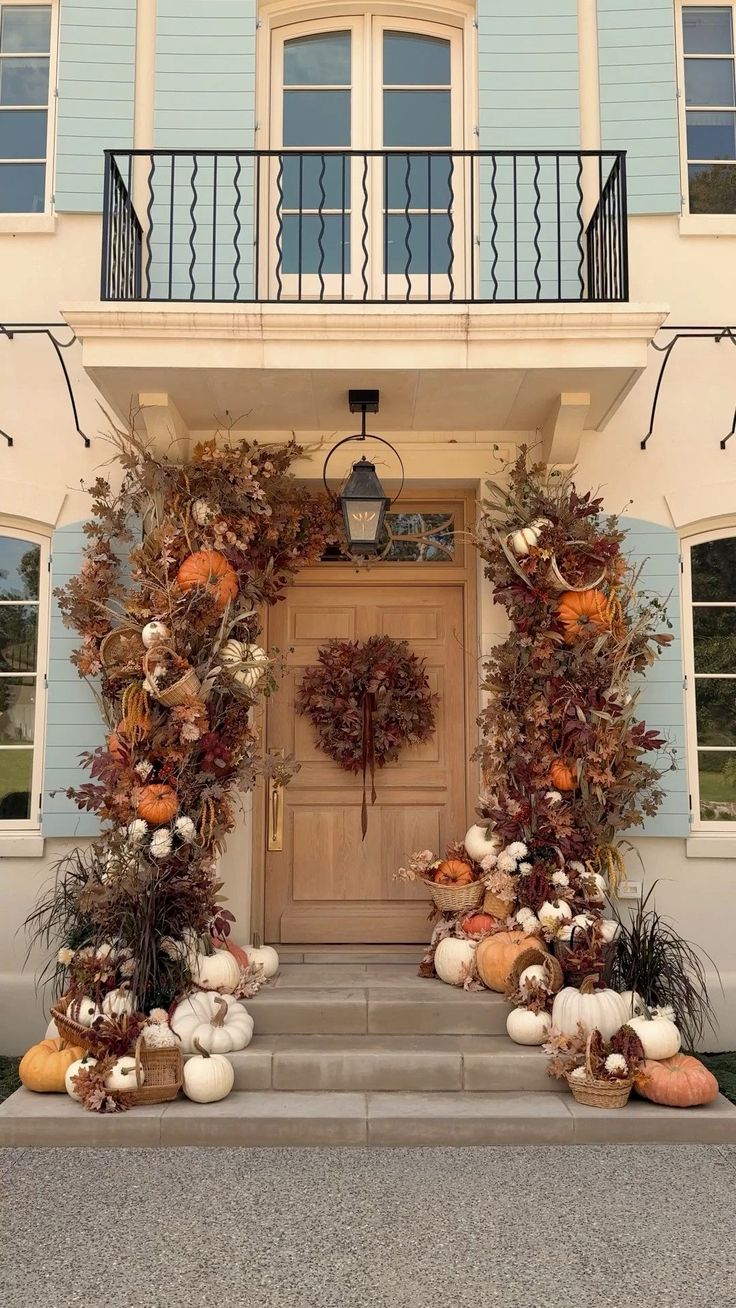 Grand fall entry with dried floral arches and heirloom pumpkins