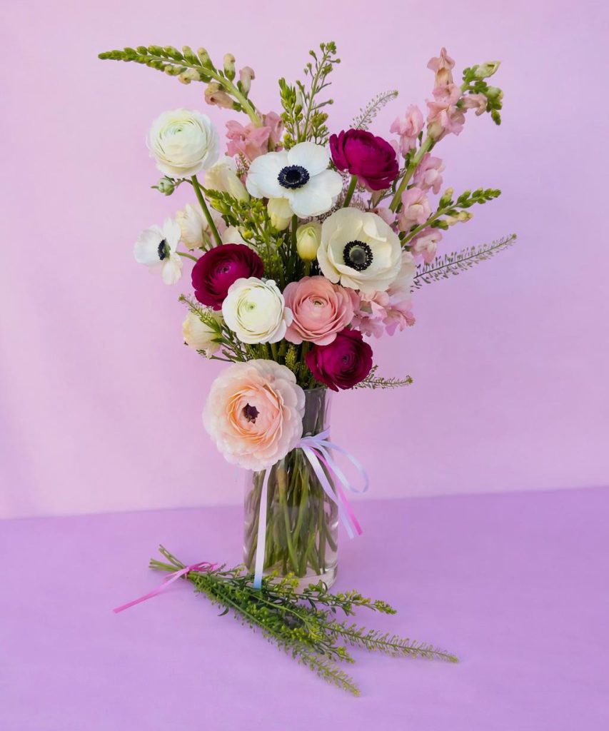 Garden-style keepsake vase arrangement with soft pinks and buttery yellows