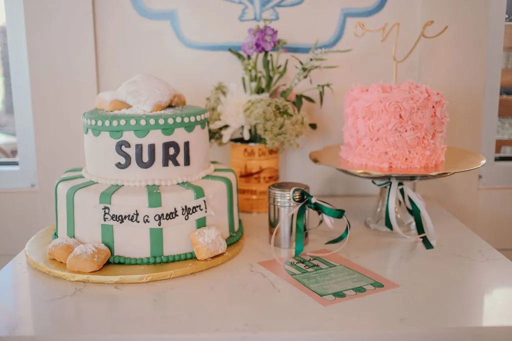 Dessert table with tiered green cake and pink rosette cake