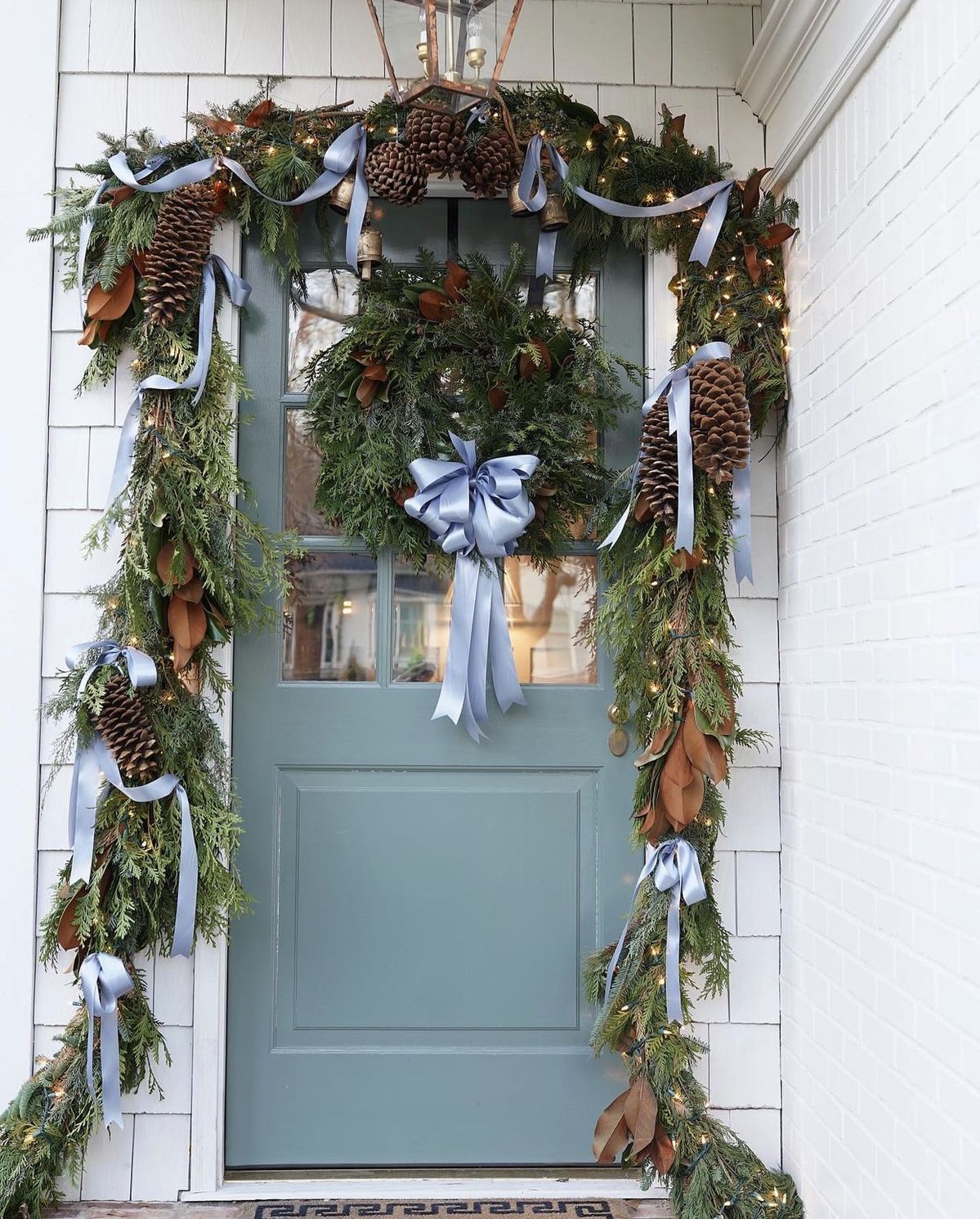 Magnolia and cedar door frame with pale blue satin ribbon